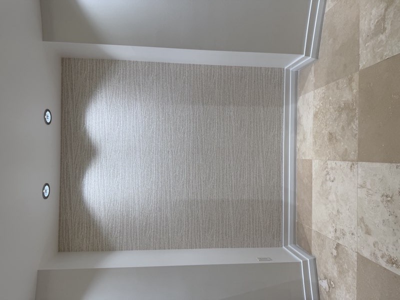 Finished textured wallpaper niche with recessed lighting