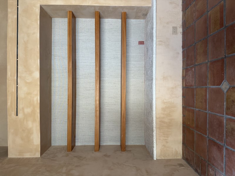 Finished grasscloth wallpaper niche with wood battens